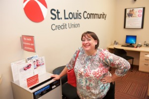 Woman leaning on a shred paper drop-box in a bank.