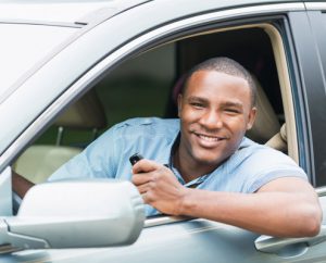 Man in car smiling while holding car keys