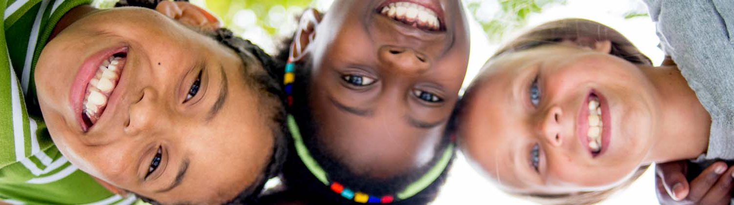 Three kids smiling.