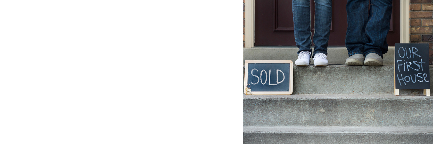 Image of two people's feet on steps with two signs beside them reading "Sold" and "Our first house"